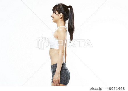 Shot of beautiful slim body of woman in white lingerie on beige
