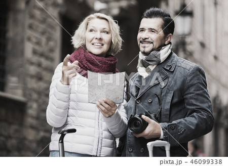 couple with suitcases, camera and map outdoorsの写真素材 [46099338