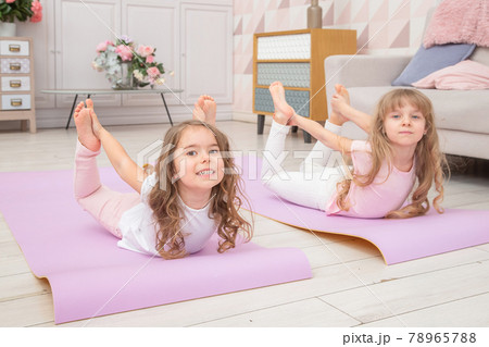 Full Length Front View Smiling Cute Girls Sitting on on Yoga Mat