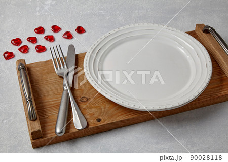 Wedding table arranged with golden cutlery and white charger plate