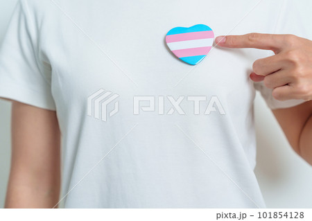 Hand holding rainbow heart on lgbt flag colours, pride month